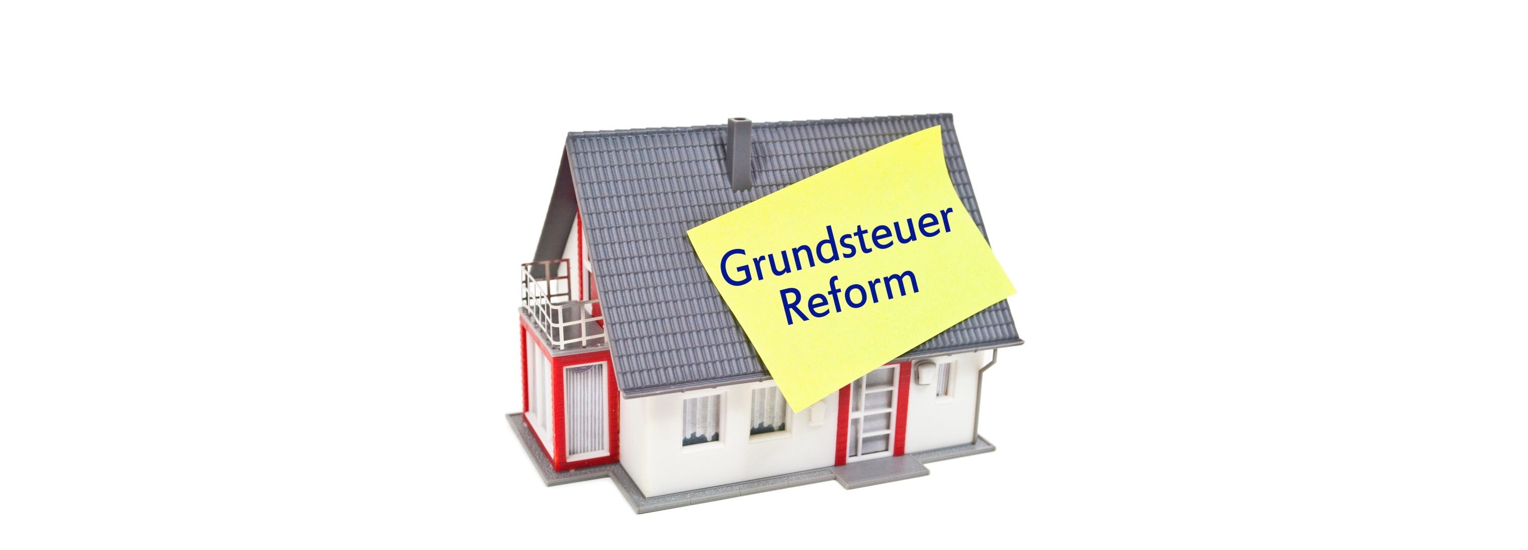 The graphic shows a house with a Post-It with the words Property Tax Reform stuck to it.
