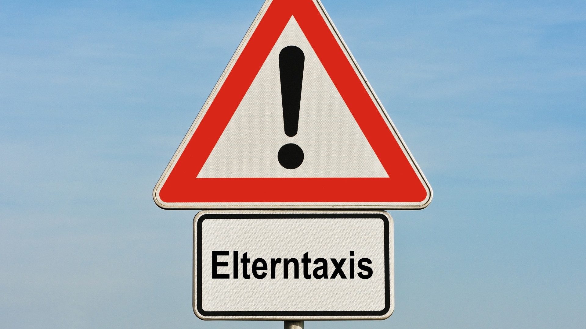 The photo shows the traffic sign "Attention danger zone" with additional sign "Parent cabs"