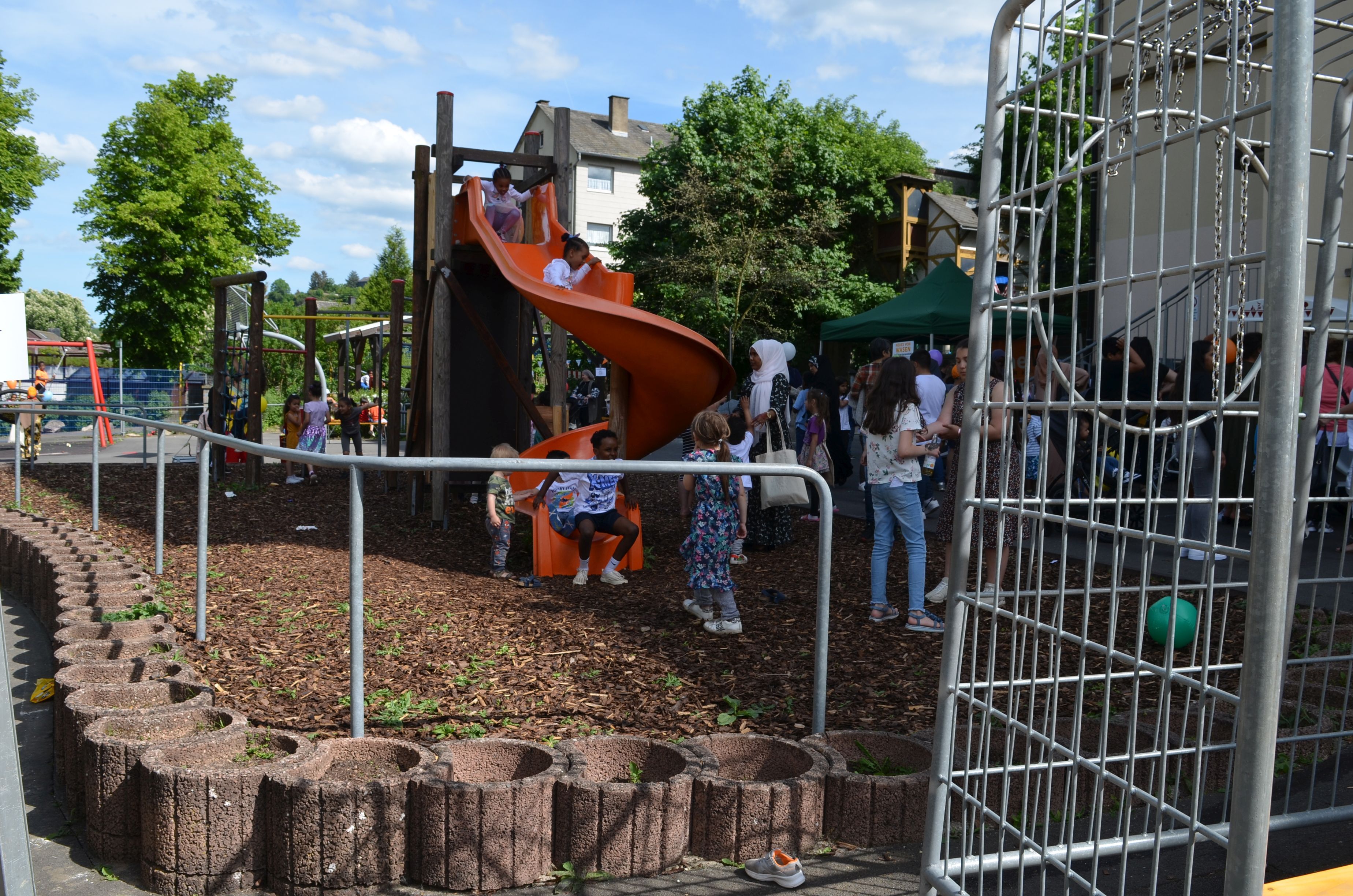 The photo shows children playing on a climbing frame.