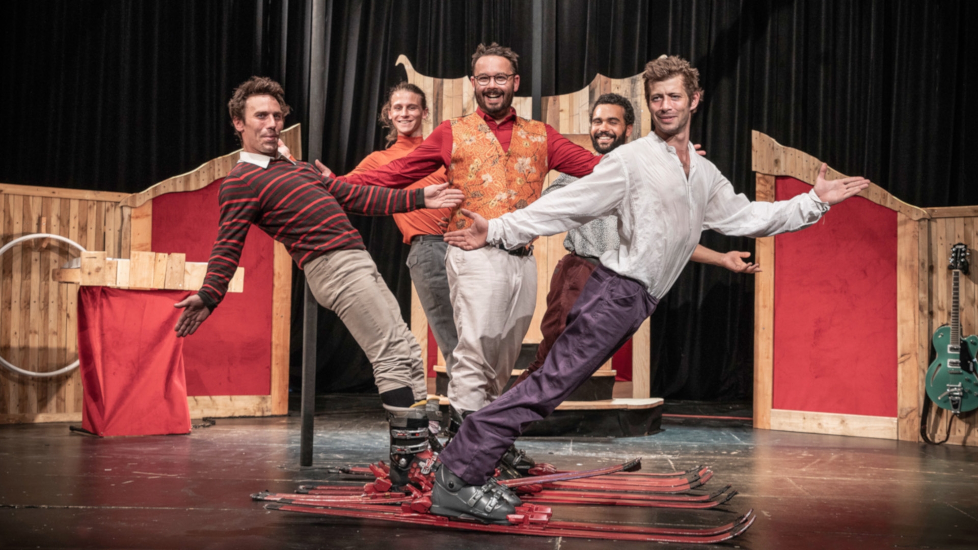 The photo shows the five artists of the Kakavresky group standing on skis in a circus ring.
