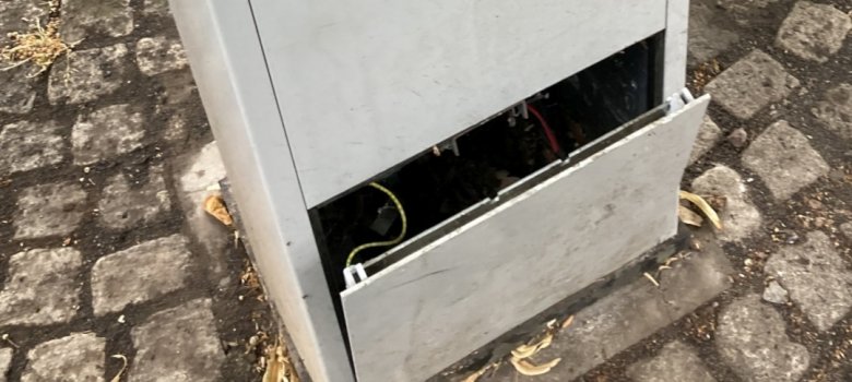 The photo shows a damaged parking ticket machine.