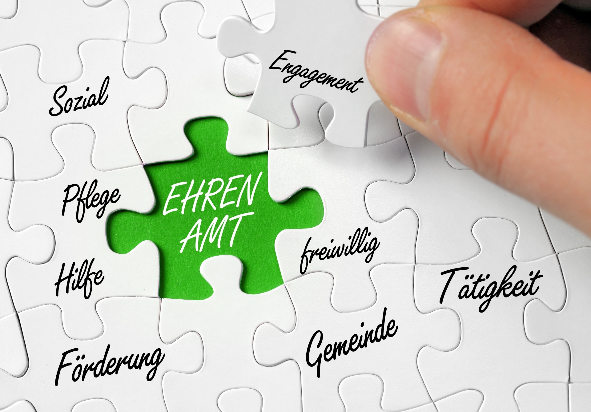 The graphic shows a jigsaw puzzle with a green piece labeled Volunteering and other puzzle pieces with various terms relating to this topic.