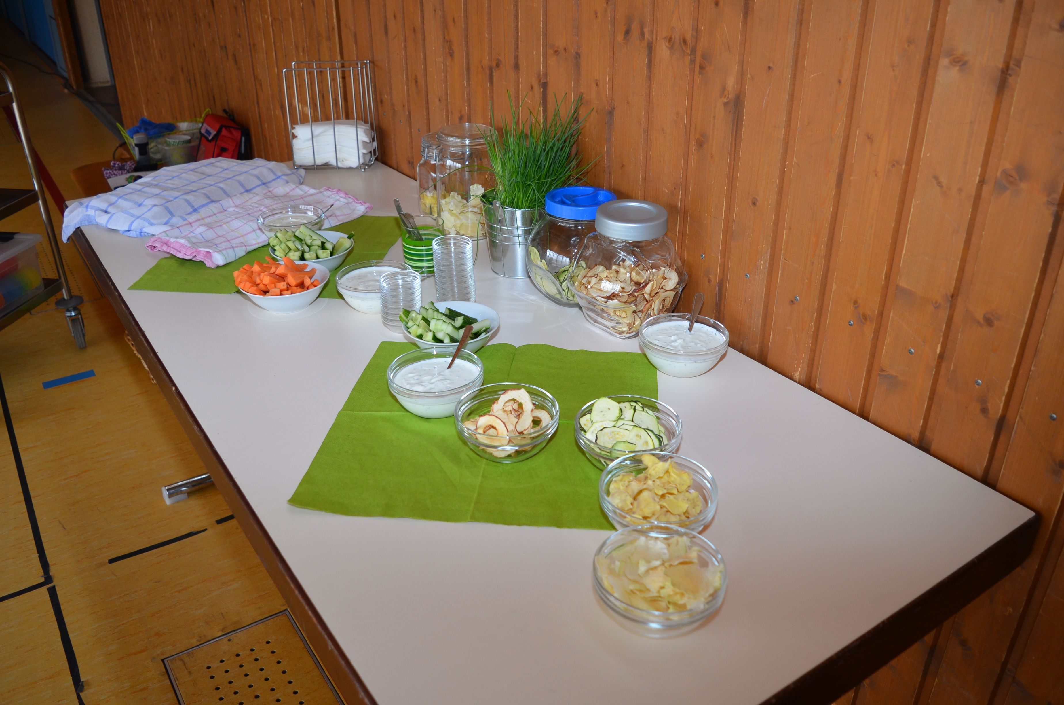 The photo shows a laid table with bowls of fruit, vegetables and other cereals.