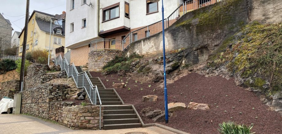 The picture shows a slope on which perennials have been freshly planted between mineral mulch.