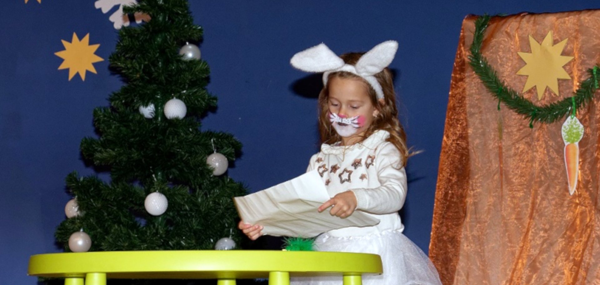 The photo shows a girl dressed as a snow bunny on stage.