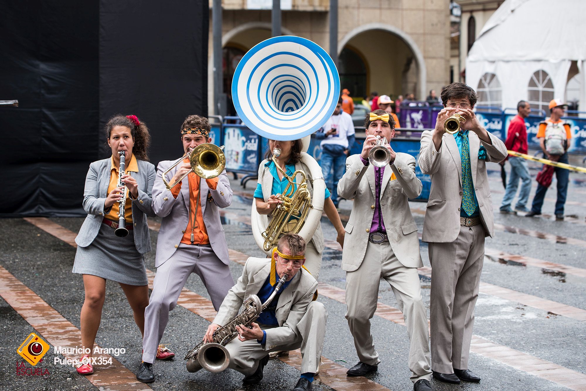 The photo shows the street theater band Calle Loca with their instruments.