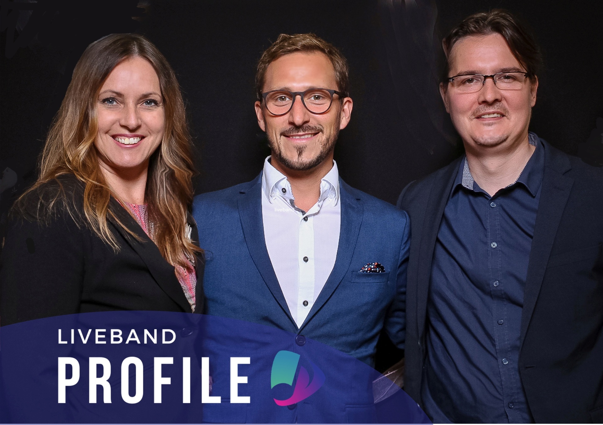 The photo shows the three band members standing next to each other and looking into the camera.