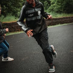 The photo shows a boy playing soccer.