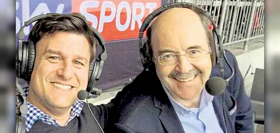 The photo shows the two people. They are sitting next to each other and have headphones with speaker microphones on their heads.