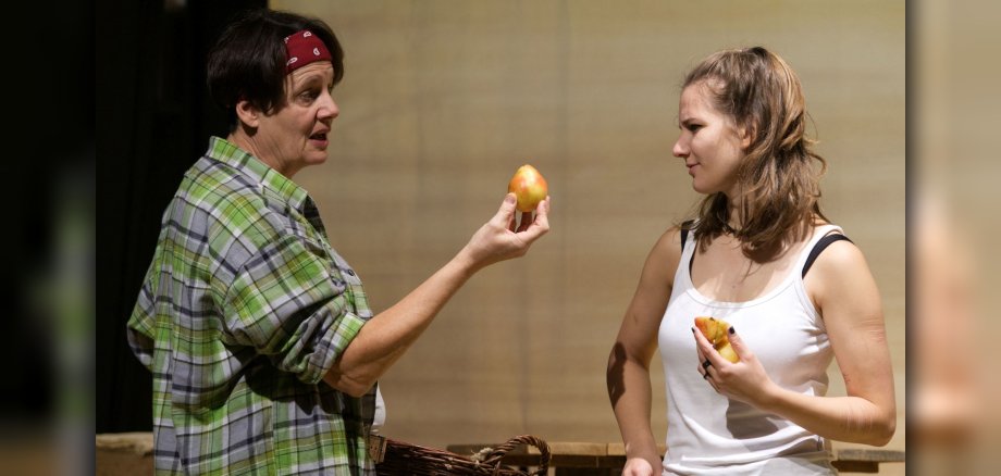 The photo shows the two actresses. They are talking to each other and holding pears in their hands.