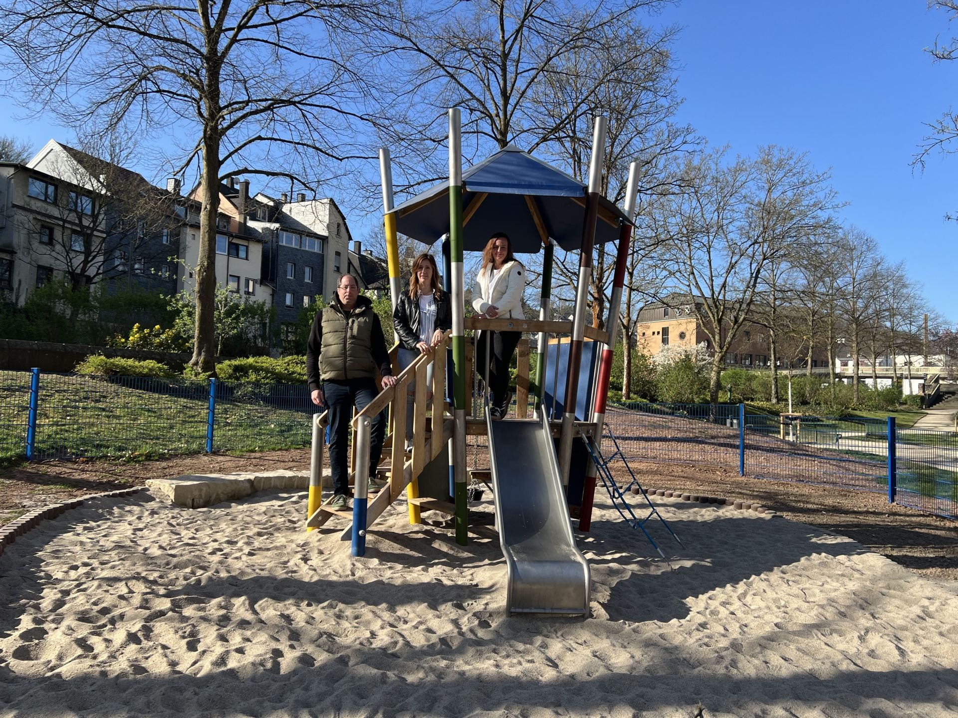 The photo shows the aforementioned people standing on the play tower.
