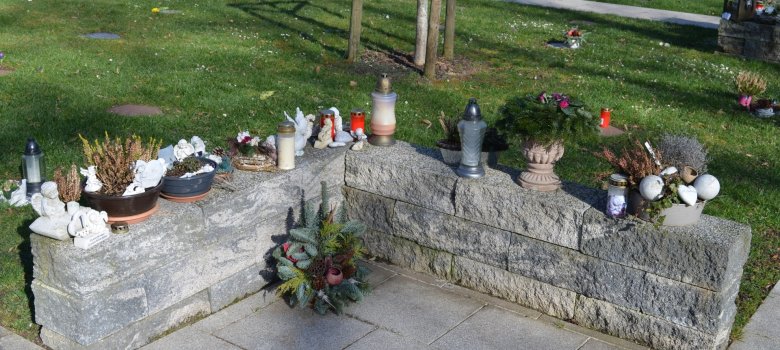 The photo shows a burial site next to a burial plot.
