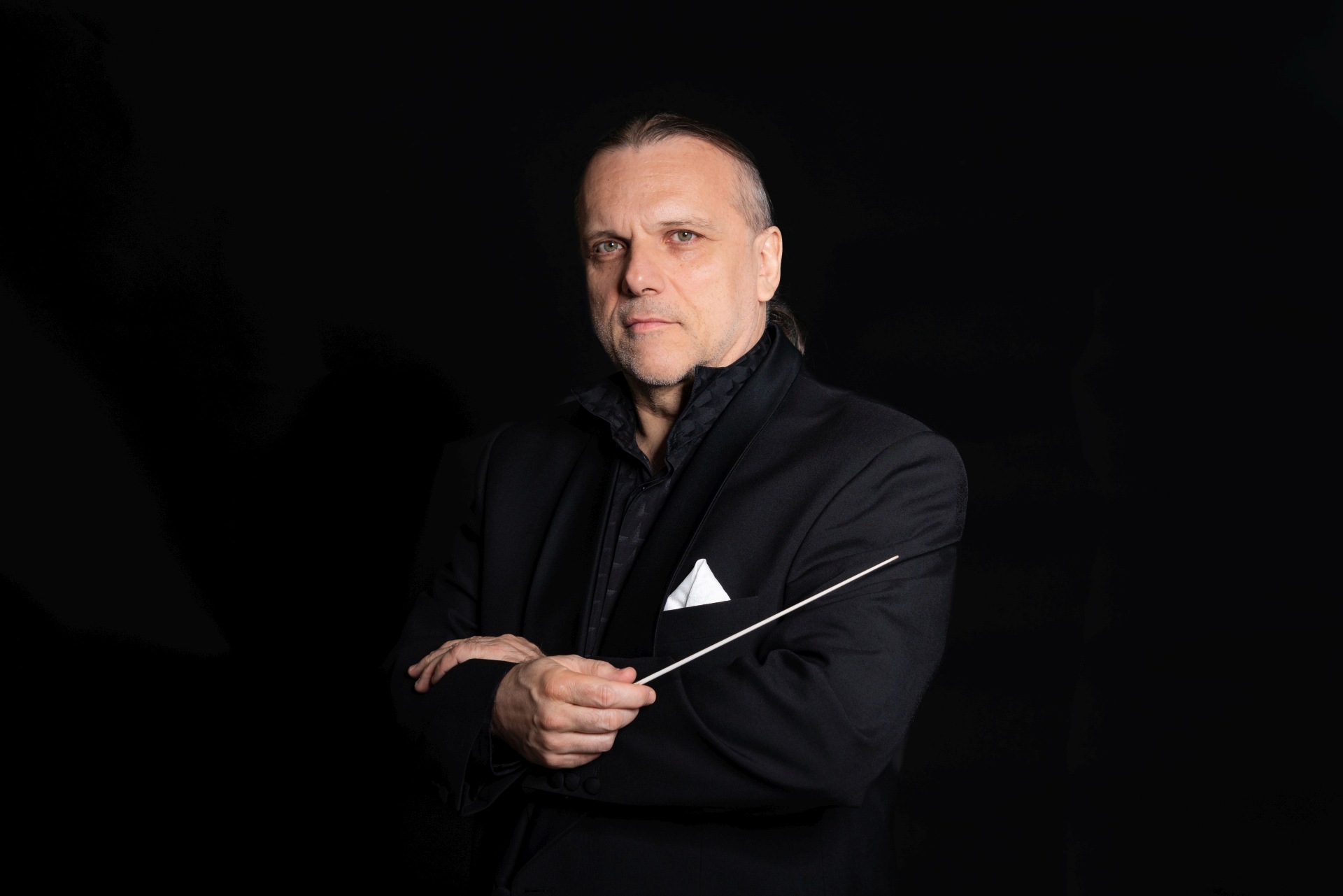 Portrait photo of Enrique Ugarte with baton.