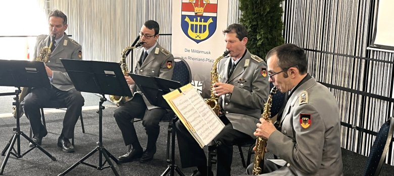 The photo shows the four musicians. They are sitting on stage with their instruments and playing.