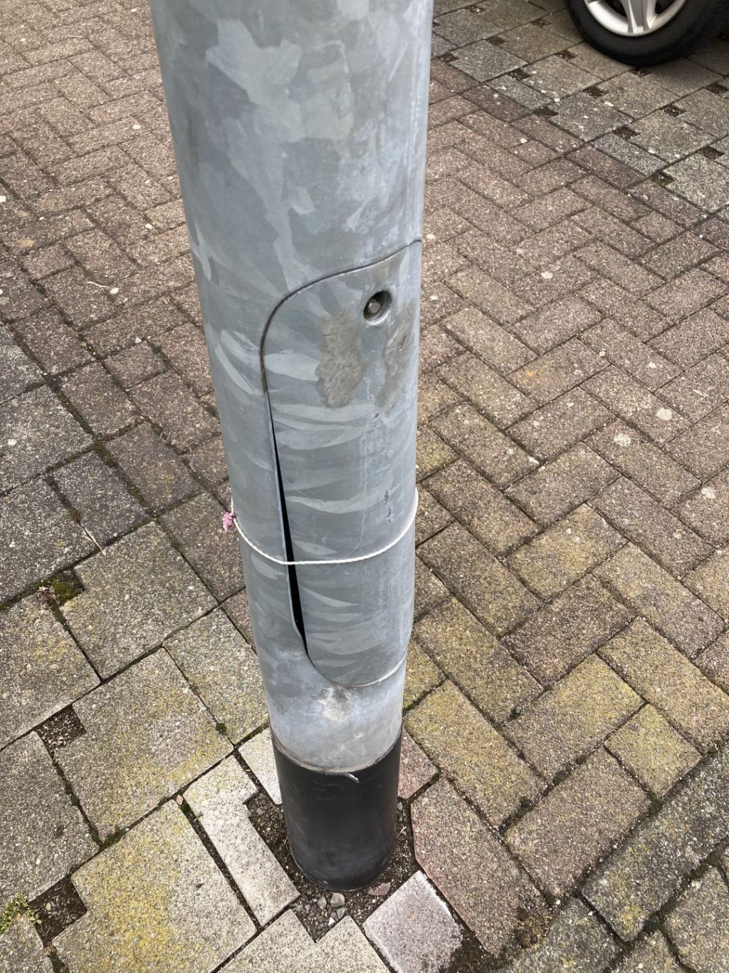 the photo shows a damaged lighting column