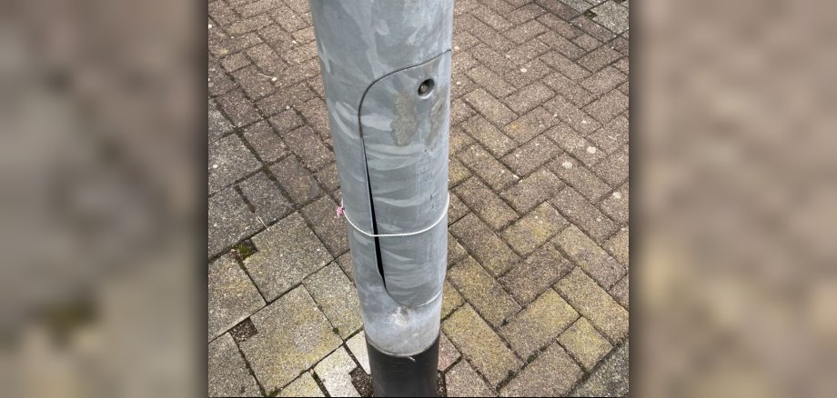 the photo shows a damaged lighting column