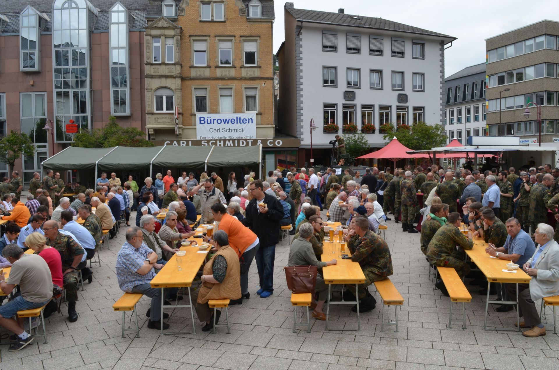 The photo shows many citizens celebrating with soldiers.