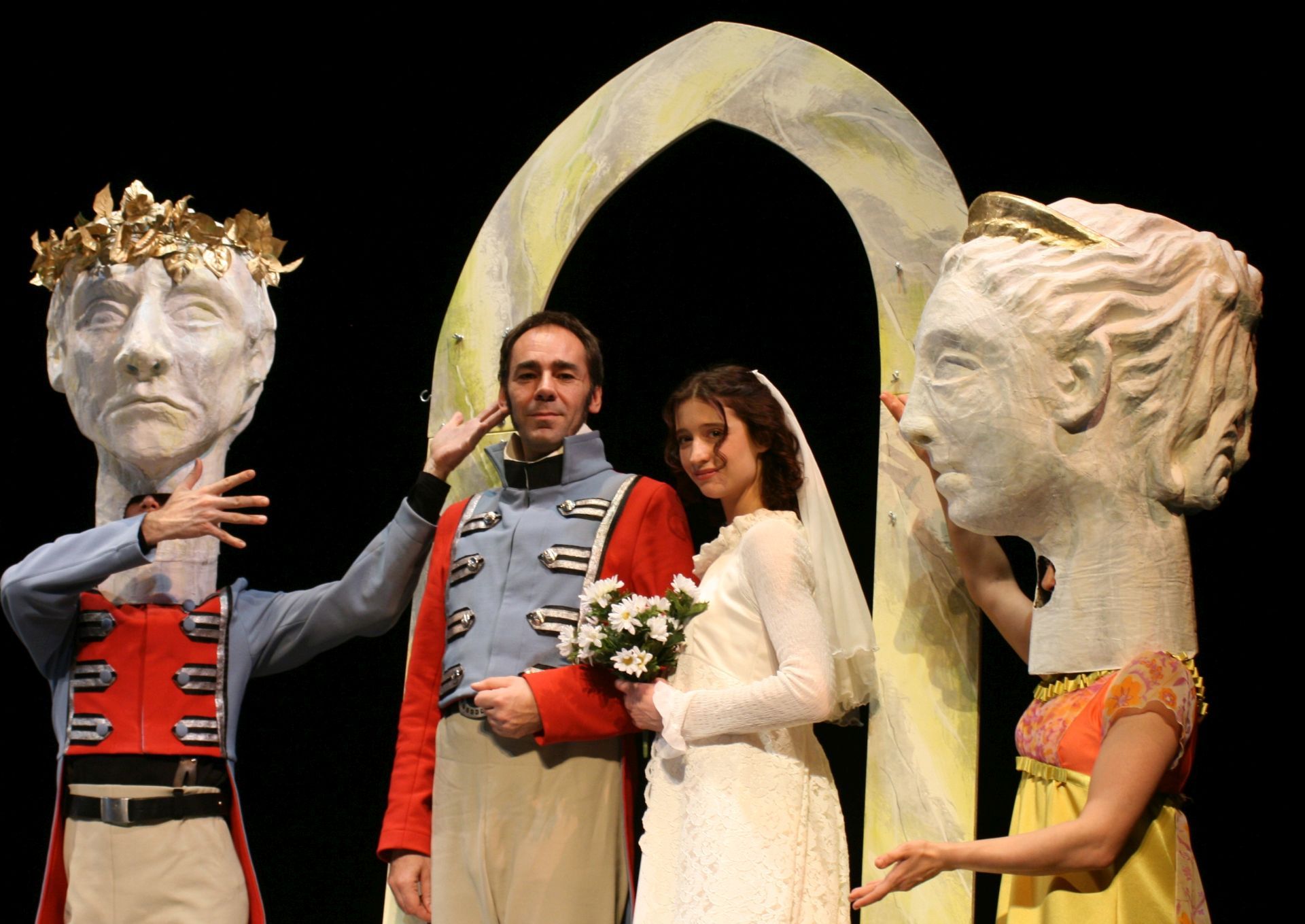 The photo shows a play scene with two people who want to get married and two others wearing masks.