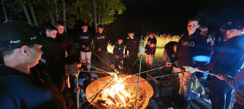 Campfire with stick bread and sausage roasting