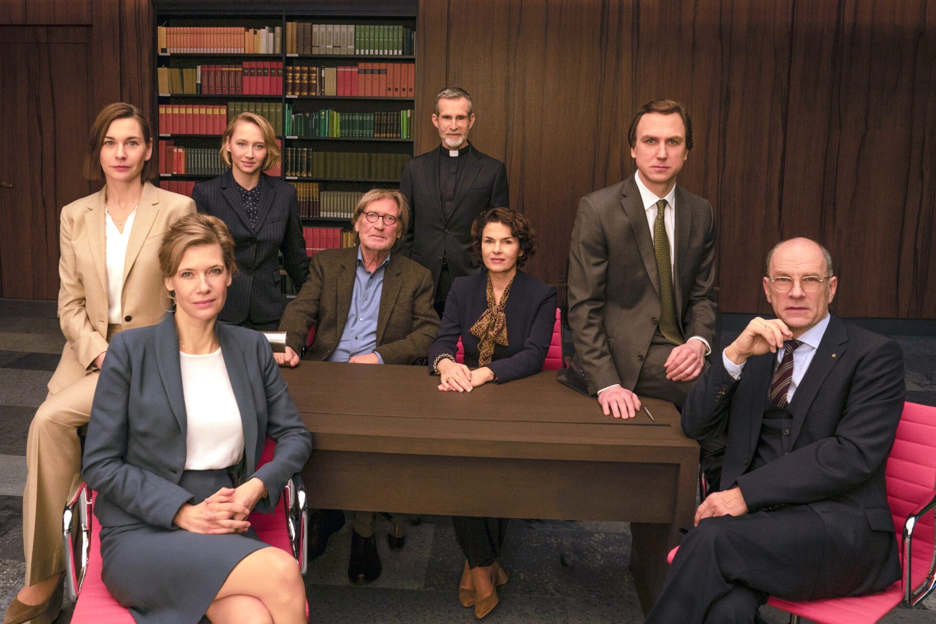The photo shows the ensemble sitting around a table.