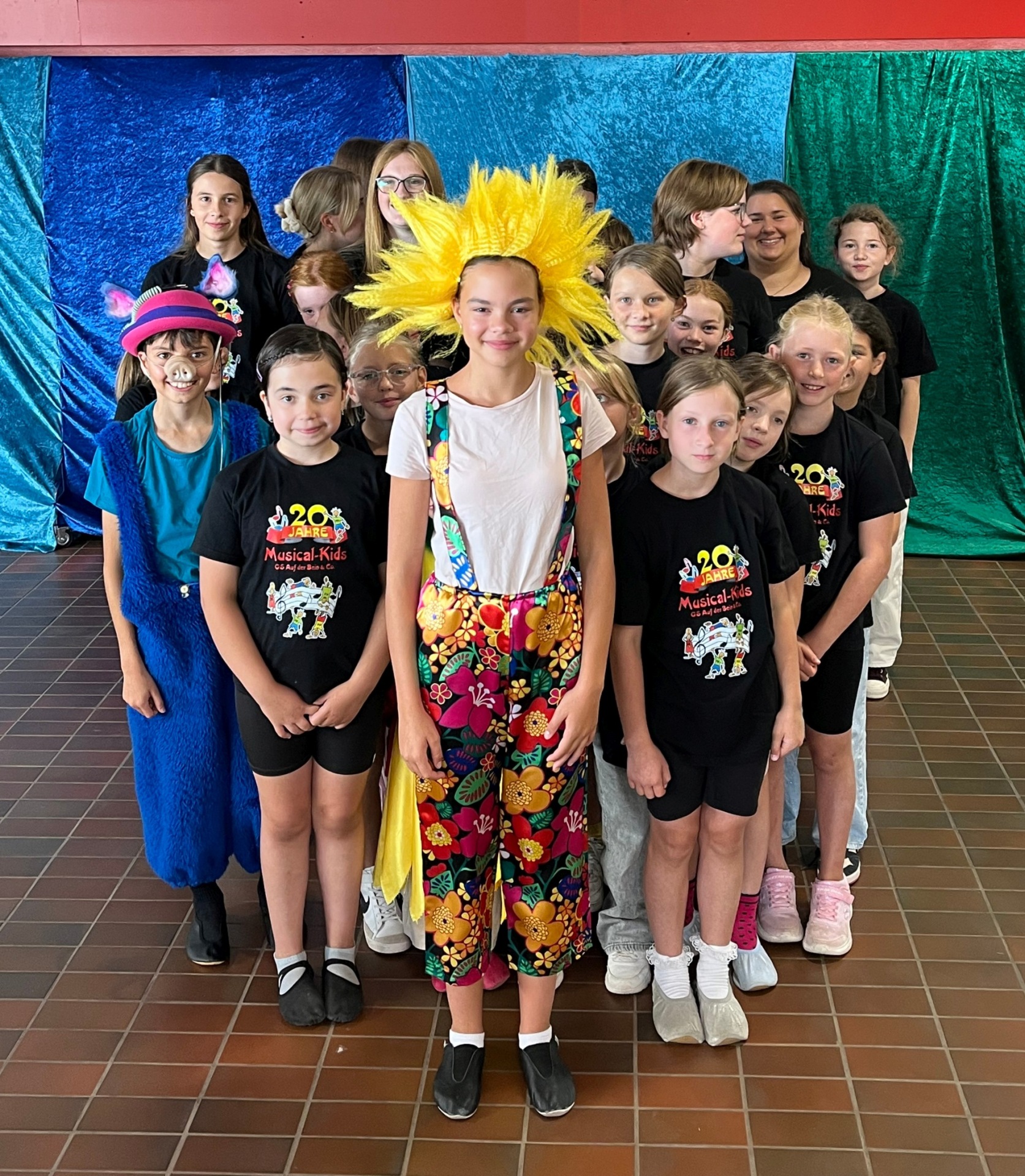 The photo shows a group picture of the musical kids.