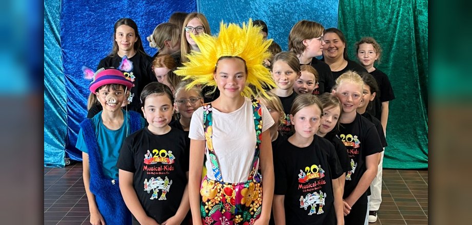 The photo shows a group picture of the musical kids.