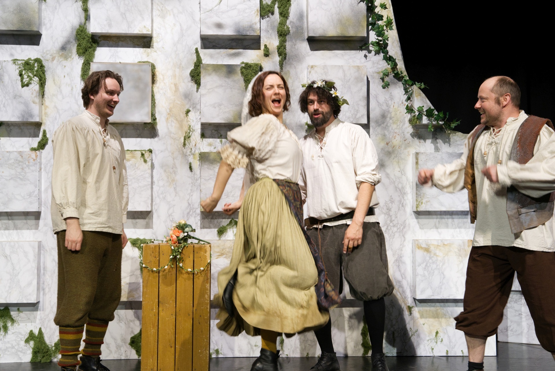 The photo shows a scene from the play with the four actors.