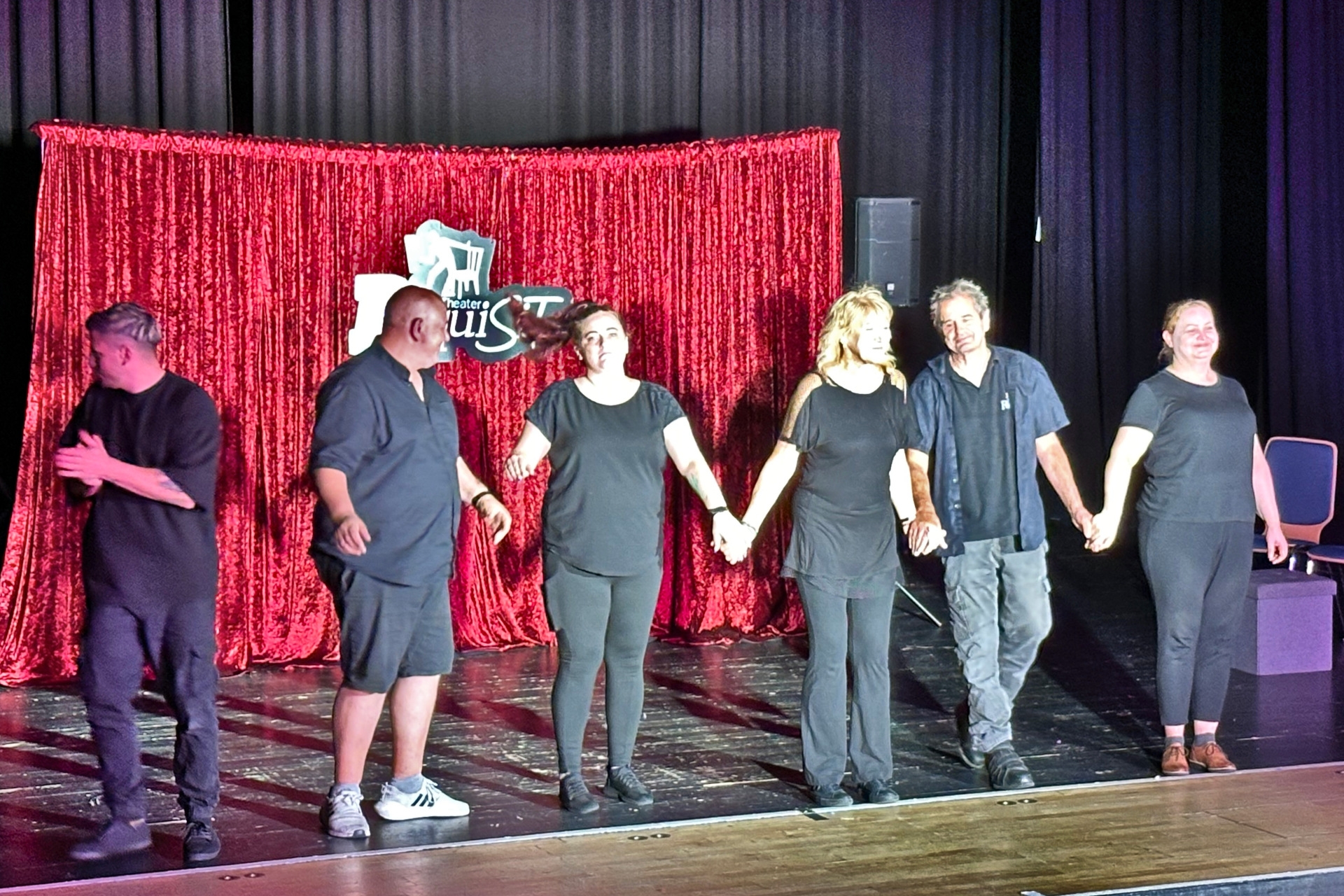 The photo shows the actors presenting themselves to the audience on stage after the performance.