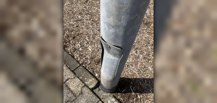 The photo shows a lamp post that was damaged in an accident.