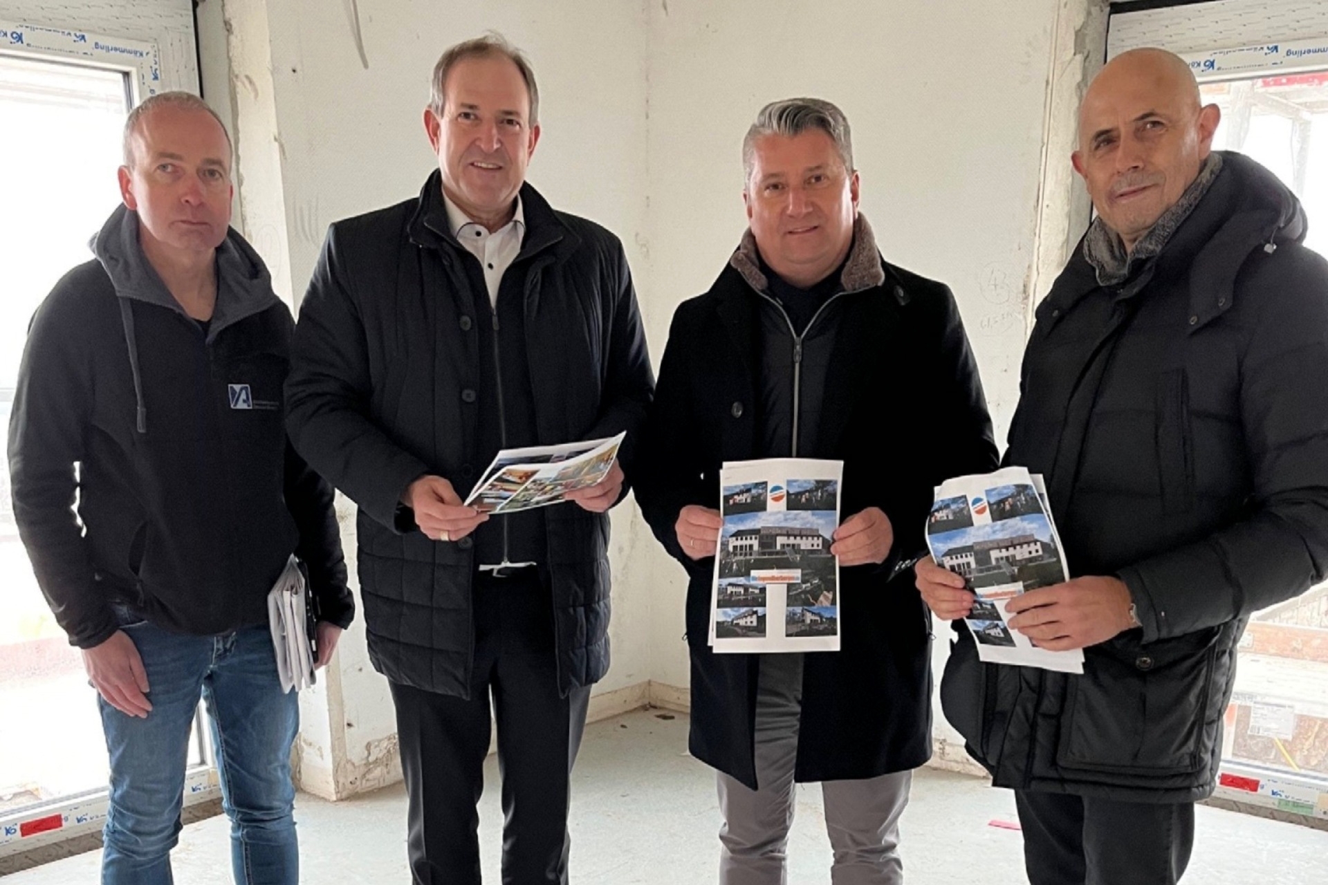 La photo montre les personnes mentionnées. Elles se tiennent sur le chantier et regardent la caméra.