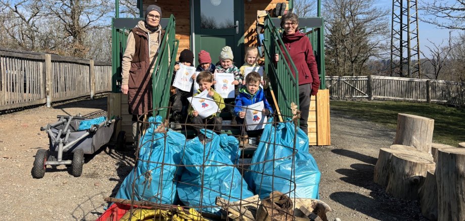 La photo montre les enfants et deux éducateurs avec les déchets ramassés.