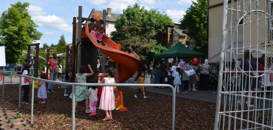 Das Foto zeigt den Schulhof der Flurschule und viele Kinder, die am Klettergerüst spielen. 