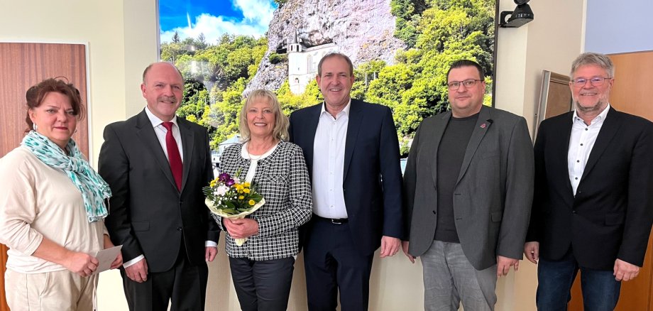 Das Foto zeigt die sechs Teilnehmer der Verabschiedung. Frau Endres hält einen Blumentstrauß in der Hand.