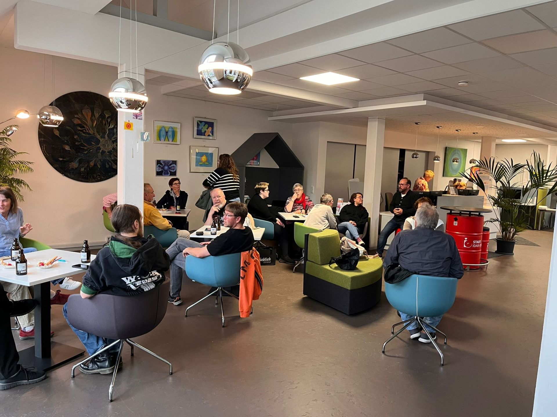 Die Teilnehmer der Pub-Quiz-Night sitzen bequem in den Sesseln der Stadtbibliothek,